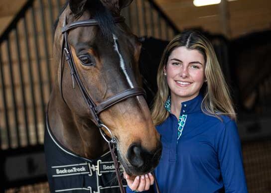 Baylee in Green is the New Blue, standing with HH Azur